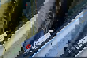 Car lockout service unlocking vehicle door for customer by automotive locksmith.