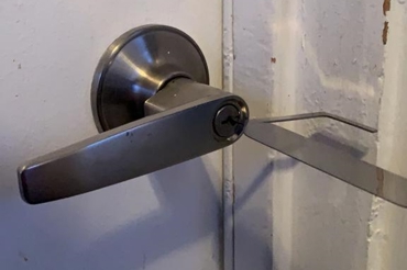 pick lock tools to open a commercial lever handle door lock.