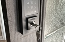 Smart keypad lock with Weiser key installed for secure commercial or residential entry access.