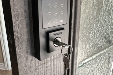 Smart keypad lock with Weiser key installed for secure commercial or residential entry access.