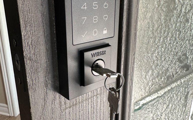 Smart keypad lock with Weiser key installed for secure commercial or residential entry access.
