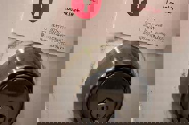 LockTech car and home locksmith business card above a new deadbolt lock on residential door.